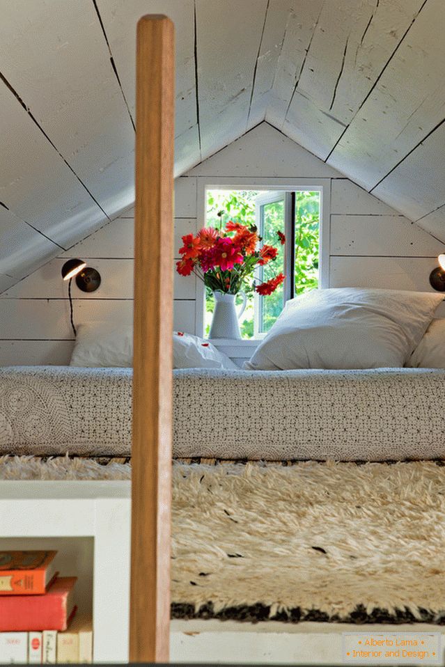 Bedroom under the ceiling in a small cozy house