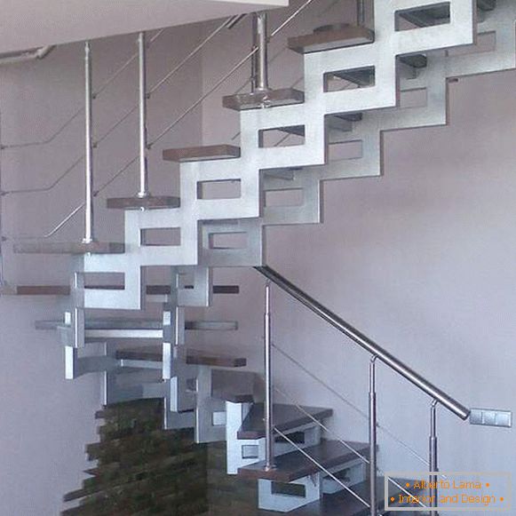 Unusual metal staircase in a private house with wooden stairs