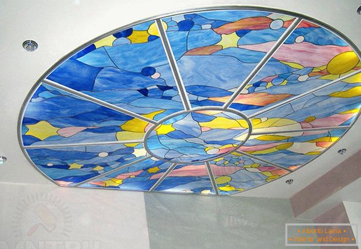 Suspended ceiling with properly selected lighting is decorated with a stained-glass film of blue color. 