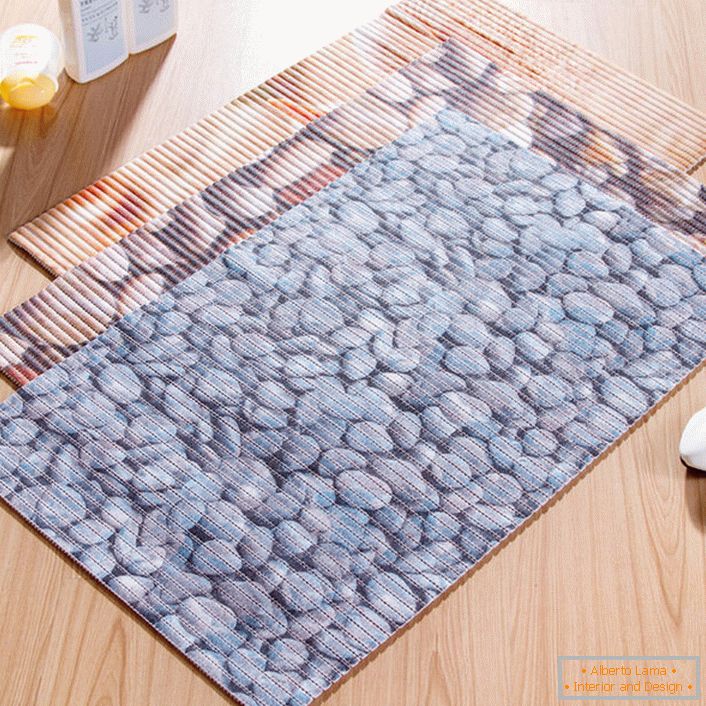 A mat with a picture of sea pebbles is an attractive and practical solution for decorating a bathroom.
