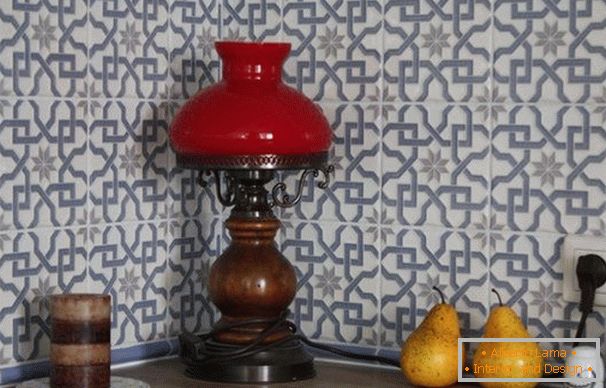 An antique lamp and an unusual tile