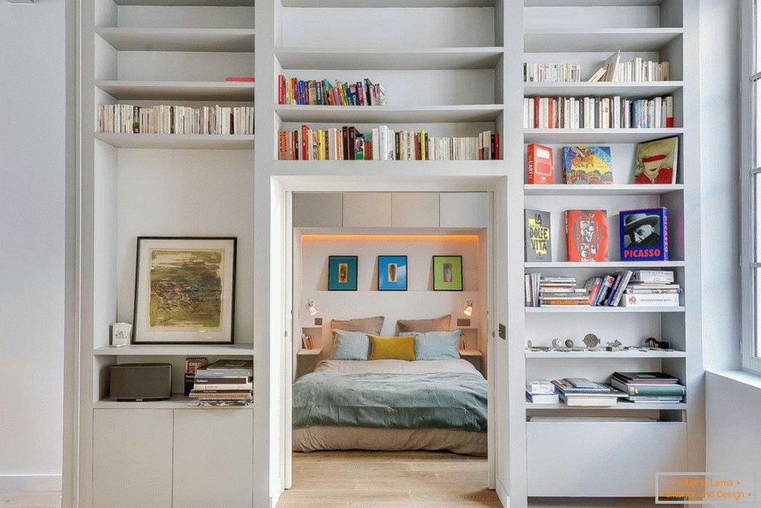 Shelves on the wall that separates the two rooms