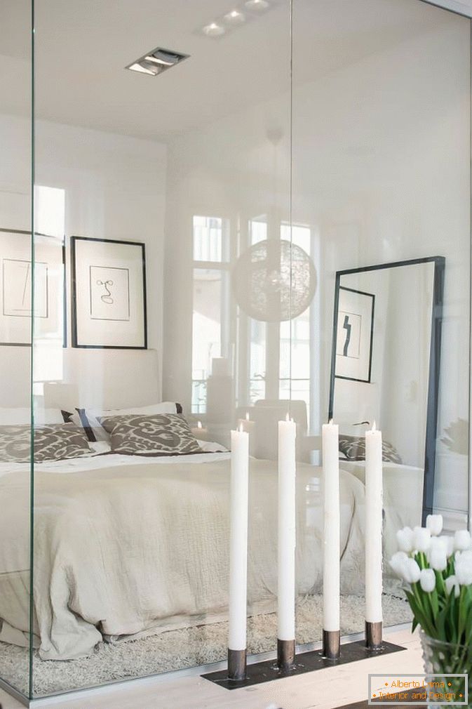 Bedroom behind the glass studio apartments in Scandinavian style