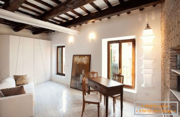 Wooden ceiling beams in studio apartment