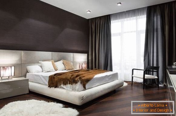 Double bed with a soft headboard of light color
