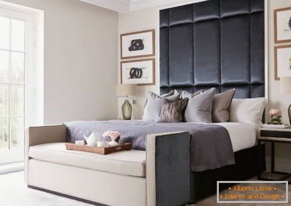 Modern bed with a high soft headboard in the interior