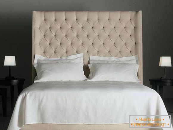Double bed with a high soft beige headboard