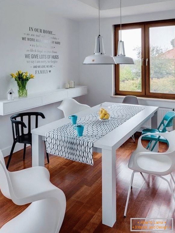 White dining table and multi-colored chairs