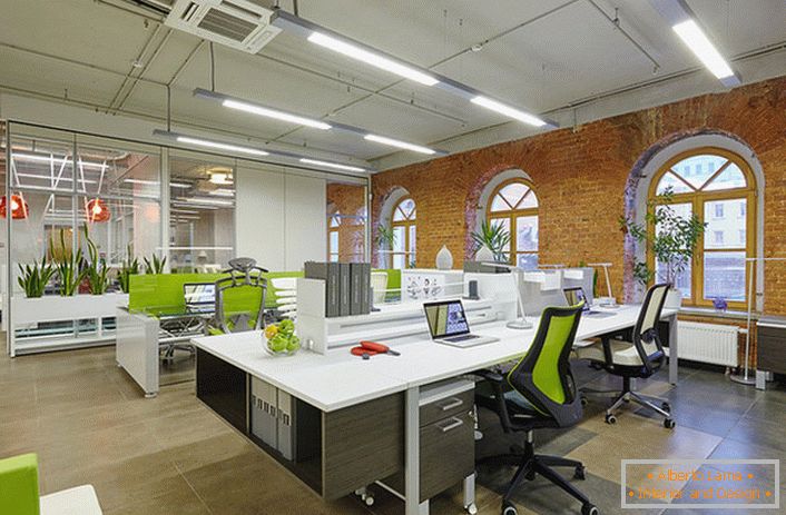 To design an office in the loft style, a lot of lively greenery is used, which makes the room cozy and adjusts employees to a working mood. 