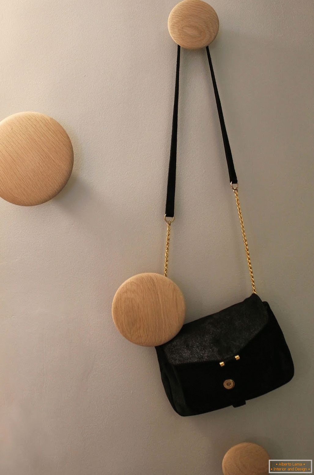 Wooden hangers on the wall of a stylish small studio apartment