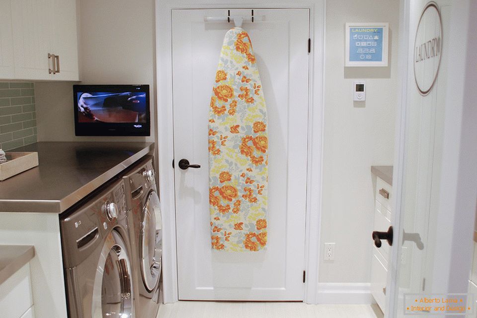 Hook for storing the ironing board in the interior of a small laundry