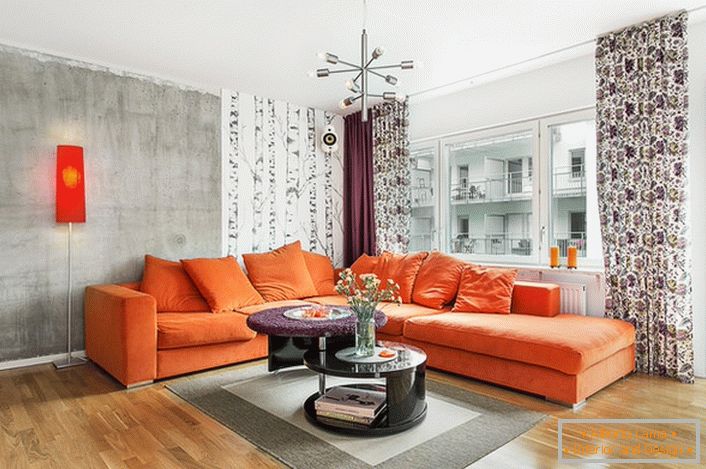 Scandinavian style is inherent in the use of warm colors in the interior design. Soft orange sofa organically looks on the background of the walls of a cold-gray hue.