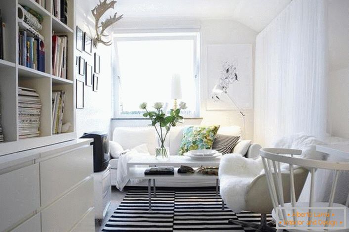 The classic combination of black and white looks profitable in the interior in the Scandinavian style. White furniture makes the living room light and cozy.