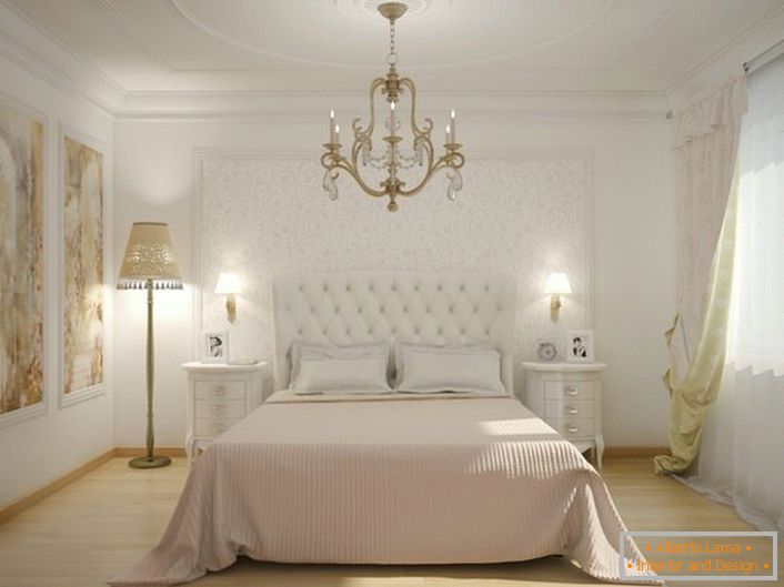 In the center of the interior of the bedroom is a bed with a high, upholstered cloth headboard. Soft, quilted upholstery makes the atmosphere noble and stylish.