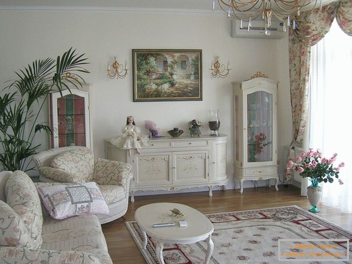 The spacious living room is decorated in a romantic style in light colors.
