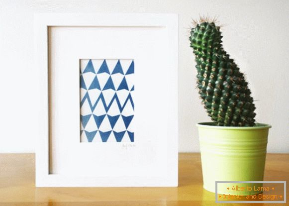 A picture with a geometric print and a cactus