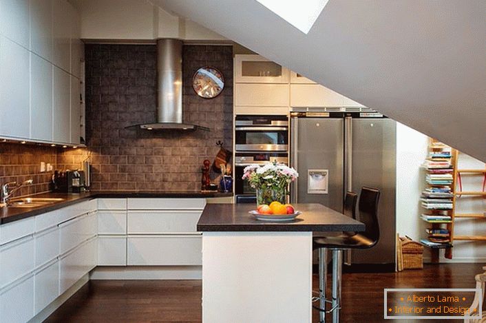 The kitchen in the attic is decorated in Scandinavian style. White kitchen sets look good against the backdrop of the walls of dark bricks. 