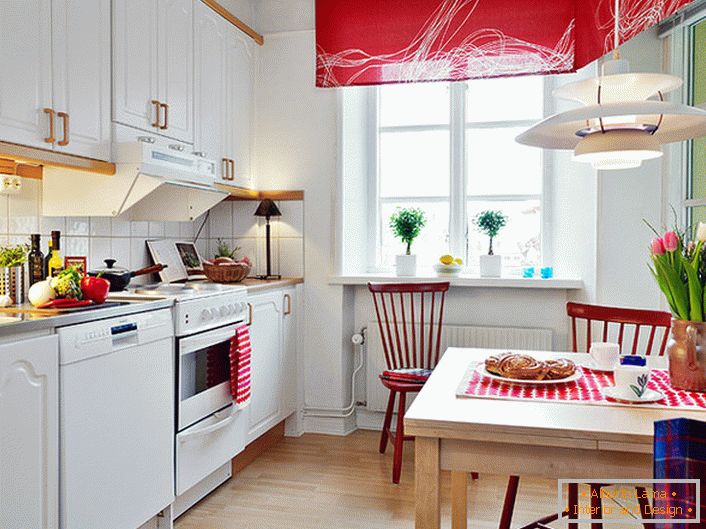 White color in combination with noble red visually enhances the kitchen. Bright, saturated accents make the room stylish and creative. 