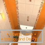 The combination of white and orange tiles in the design of the toilet