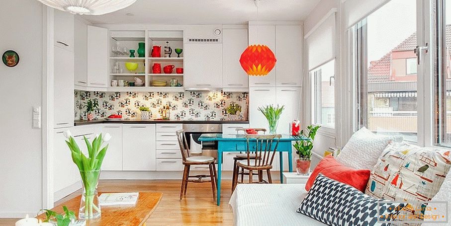 Bright accents in the interior of the white studio apartment