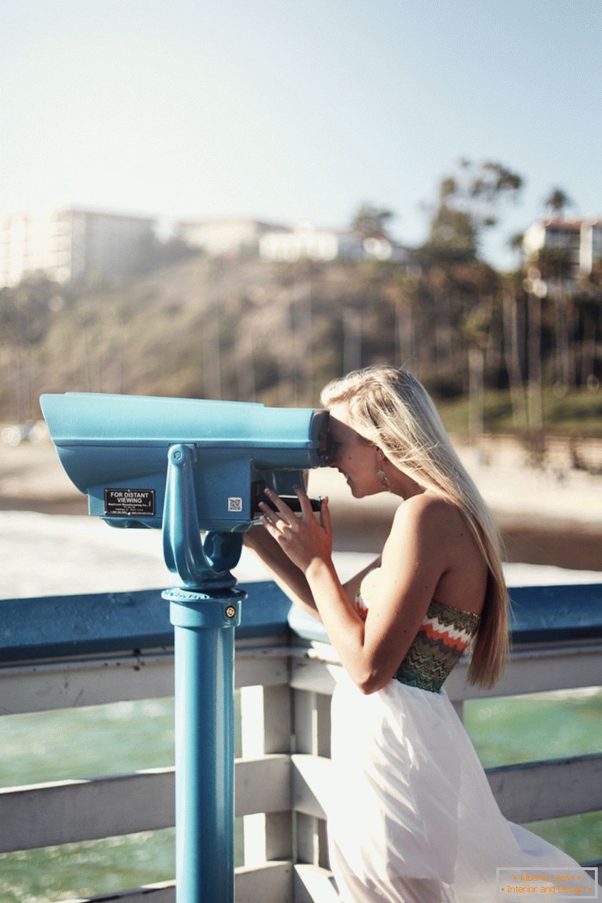 Portrait of a girl looking at street binoculars