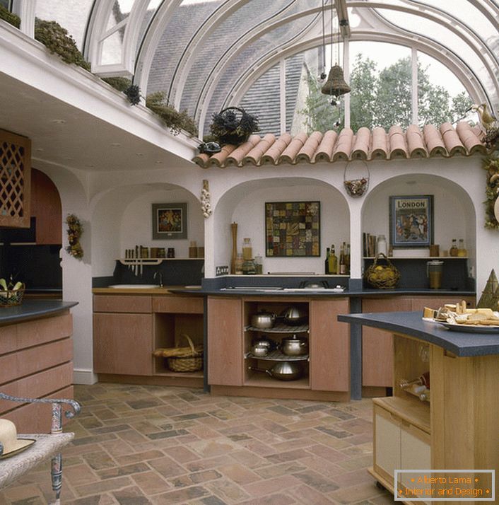 Kitchen in the Mediterranean style under a glass roof in a house in southern Italy.