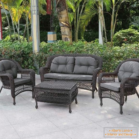Braided couch and armchair made of artificial rattan