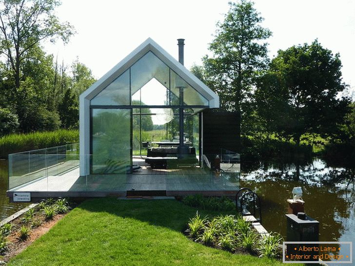 Small glass house near the lake in Holland