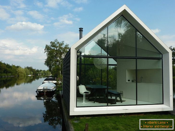 Small glass house near the lake in Holland