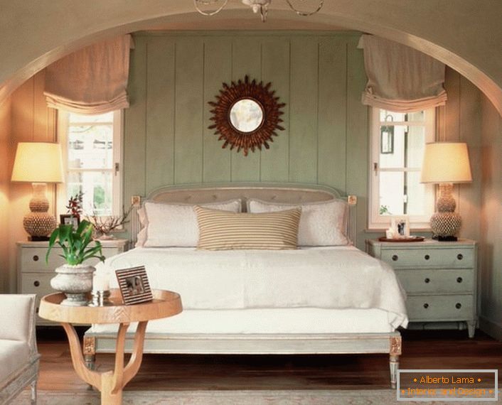 Family bedroom in country style. The warmth of the home, as well as possible, is emphasized by a soft, volumetric bed, covered with pillows.