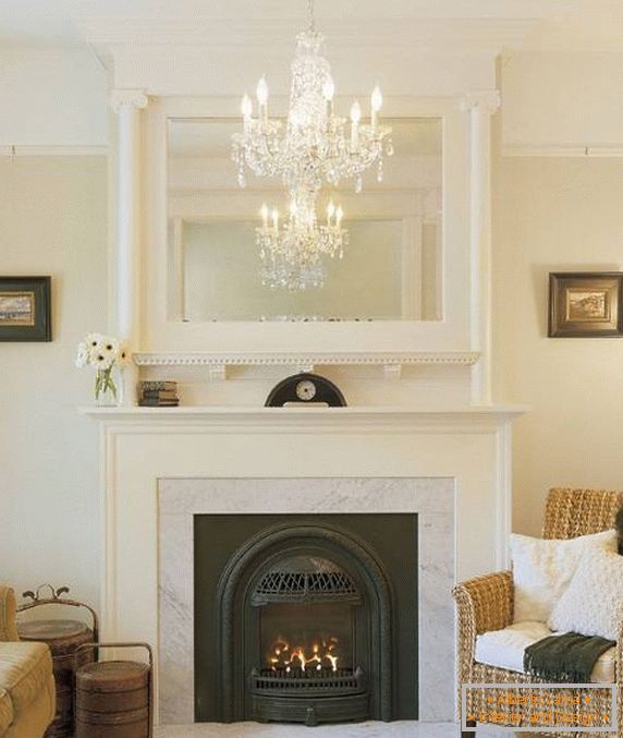 Chandelier in the mirror above the fireplace