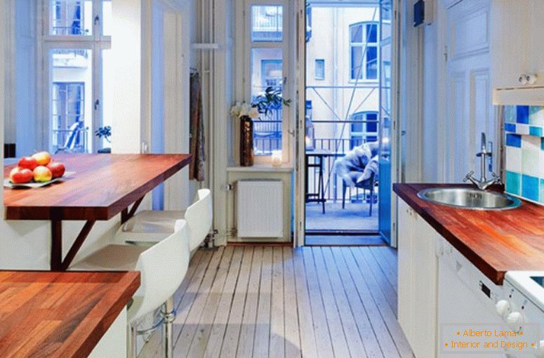 Kitchen interior with access to the balcony in a small apartment