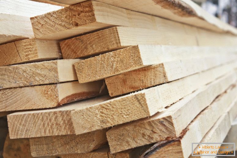 A large pile of wooden boards stored in a sawmill