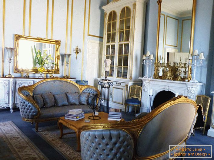Living room in the Empire style is made in soft blue colors, which harmoniously blend with the gold elements of the decor. Framing mirrors and carved furniture elements are made in a unified style.