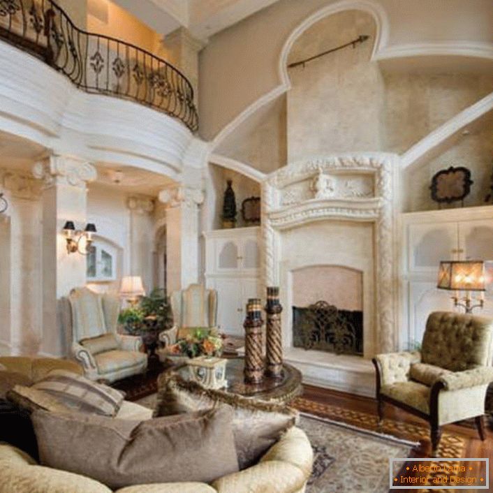 Pompous living room in Empire style with decorated white stucco fireplace. Attention attract white columns decorated with small lamps.