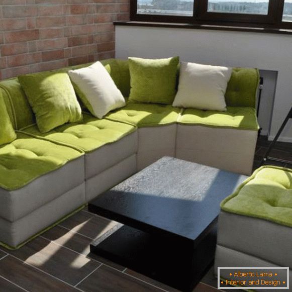 Soft sofa in the interior of the balcony