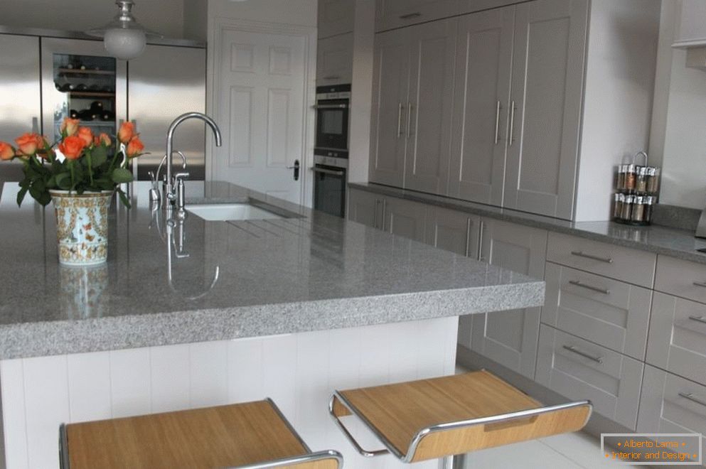 Table-island with marble countertop in the kitchen