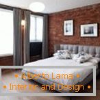 Brick wall and gray curtains in the bedroom