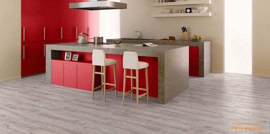 The combination of gray flooring, beige walls and red furniture in the kitchen