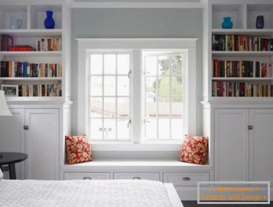 Bookcases with a banquet near the window