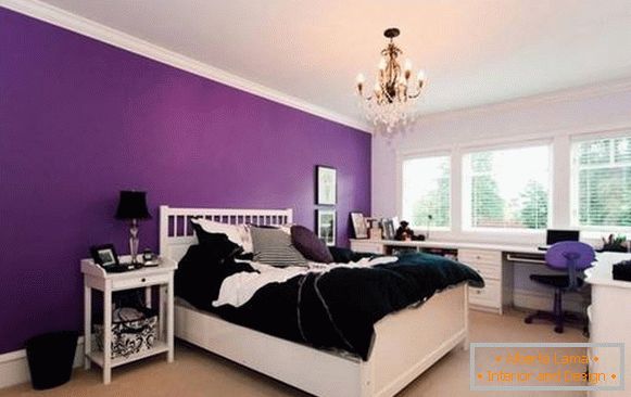Bright purple walls in the bedroom behind the headboard