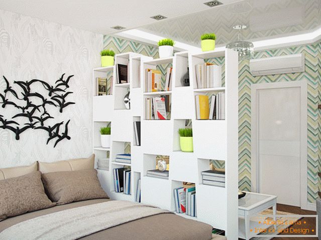 A bookshelf separating the bedroom from the living room