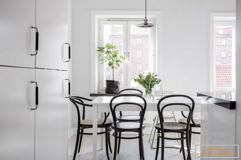 Black chairs in the white dining room