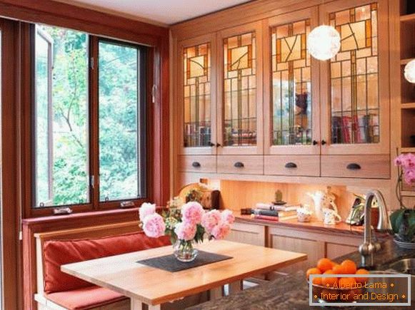 Wooden cupboard with glass doors in the kitchen