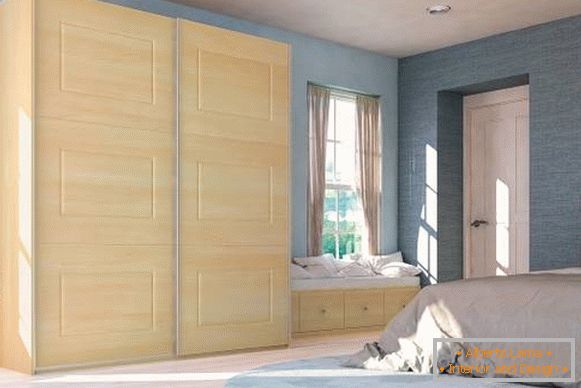 Light wooden cupboard in the bedroom