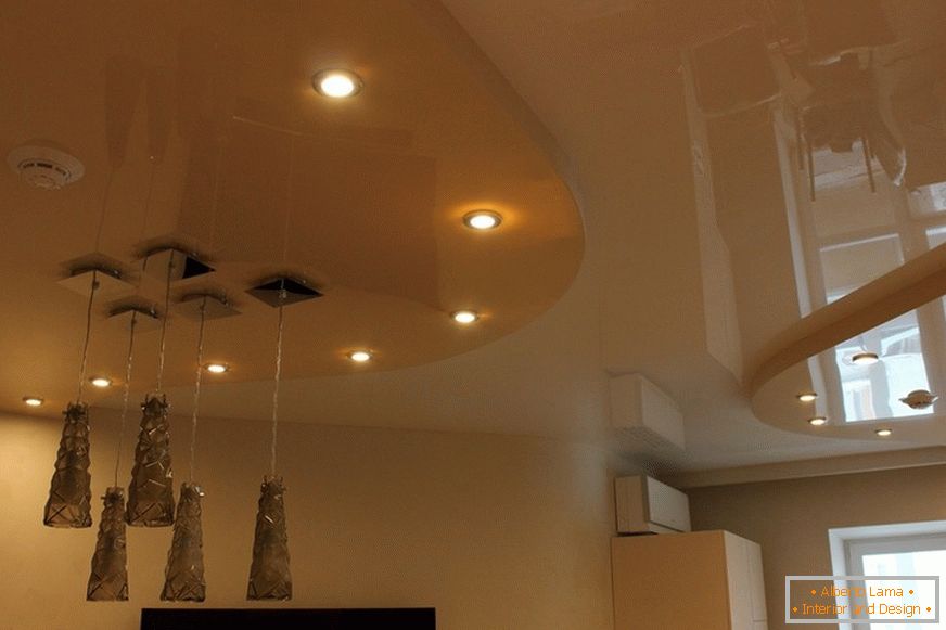 Two-level stretch ceiling PVC in the living room of the city apartment. Conceptual lighting is a good design move.