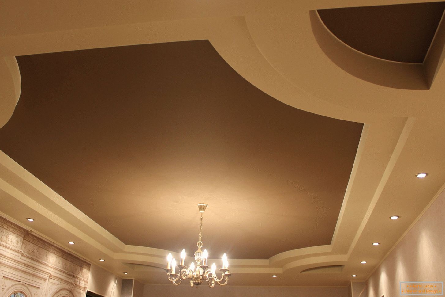 Matt stretch PVC ceilings for a guest room in a country house. The multi-tier construction of ceilings looks interesting in light beige and dark brown color.