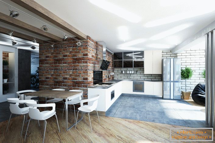The kitchen, combined with the living room, is decorated in a loft style. A laconic, discreet interior speaks of a sense of the designer's style. 