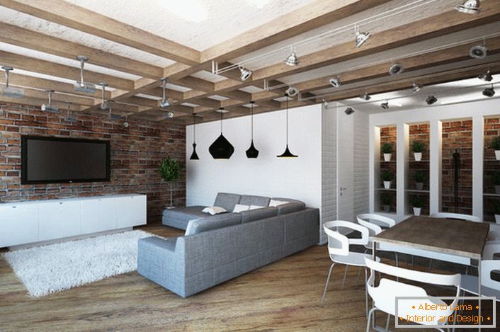 The design of the studio apartment in the loft style is notable for its practicality. A minimum of furniture makes the room spacious and bright.
