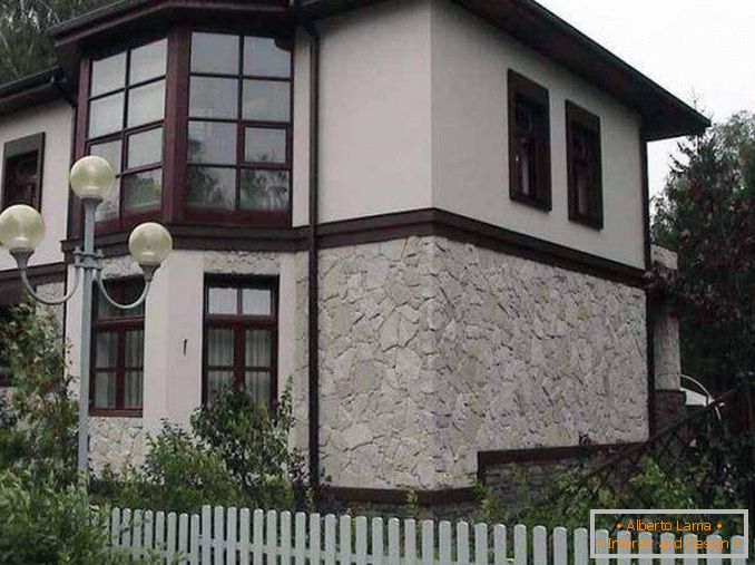 Decoration of the facades of houses with stone and plaster